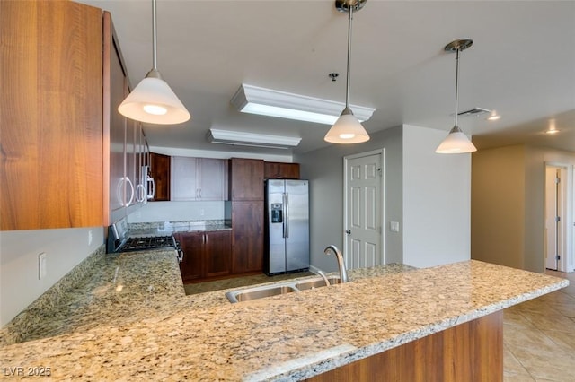 150 Las Vegas Blvd Unit 2003, Las Vegas, NV 89101 - kitchen featuring stainless steel appliances, a sink, light stone countertops, and a peninsula