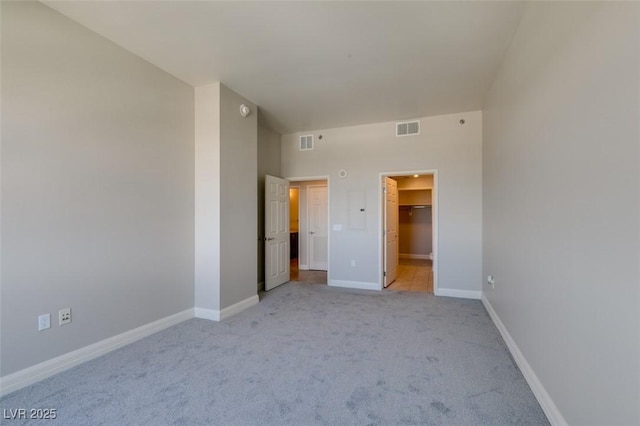 150 Las Vegas Blvd Unit 2003, Las Vegas, NV 89101 - unfurnished bedroom with light carpet, a spacious closet, and baseboards