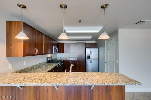 150 Las Vegas Blvd Unit 2003, Las Vegas, NV 89101 - kitchen with appliances with stainless steel finishes, a peninsula, light stone counters, decorative light fixtures, and light tile patterned floors