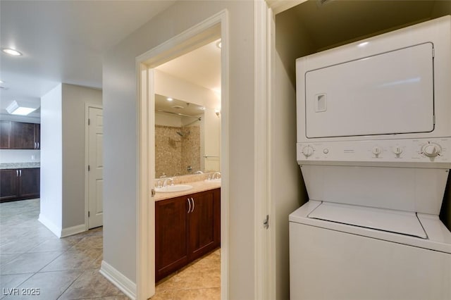 150 Las Vegas Blvd Unit 2003, Las Vegas, NV 89101 - laundry room with stacked washing machine and dryer, light tile patterned flooring, baseboards, and recessed lighting