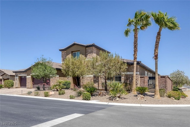 11088 Westcroft Way, Las Vegas, NV 89183 - view of front of house with stone siding, a tiled roof, and stucco siding