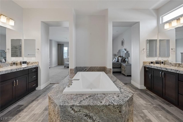 11088 Westcroft Way, Las Vegas, NV 89183 - ensuite bathroom with plenty of natural light, wood finished floors, two vanities, and a tub to relax in