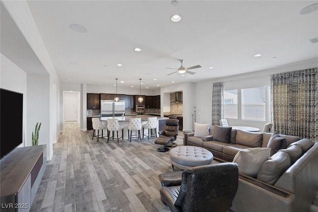 11088 Westcroft Way, Las Vegas, NV 89183 - living room featuring light wood-style flooring, recessed lighting, a ceiling fan, and baseboards