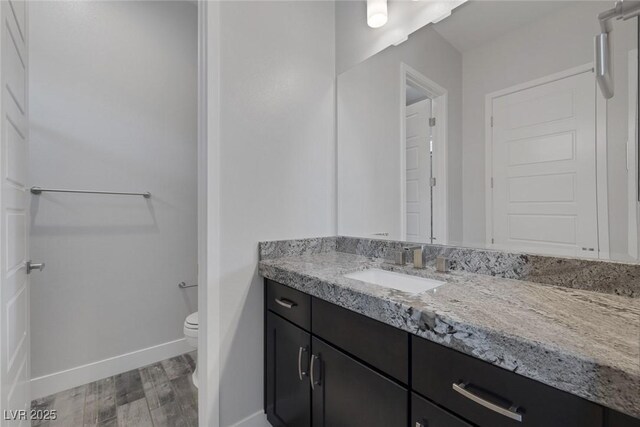 11088 Westcroft Way, Las Vegas, NV 89183 - bathroom with toilet, wood finished floors, baseboards, and vanity