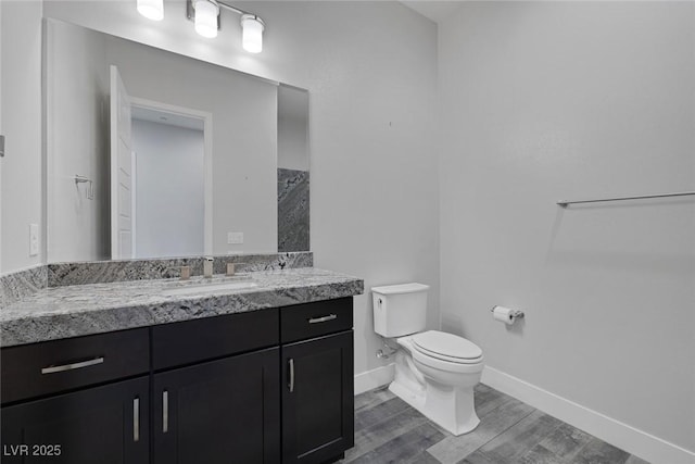 11088 Westcroft Way, Las Vegas, NV 89183 - bathroom with toilet, wood finished floors, baseboards, and vanity