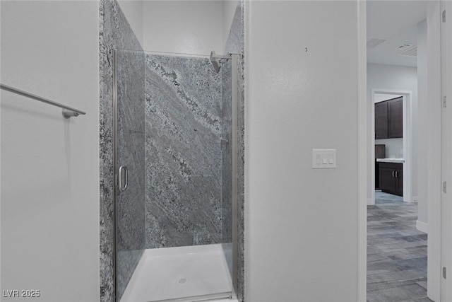11088 Westcroft Way, Las Vegas, NV 89183 - full bath featuring a stall shower, wood finished floors, and baseboards
