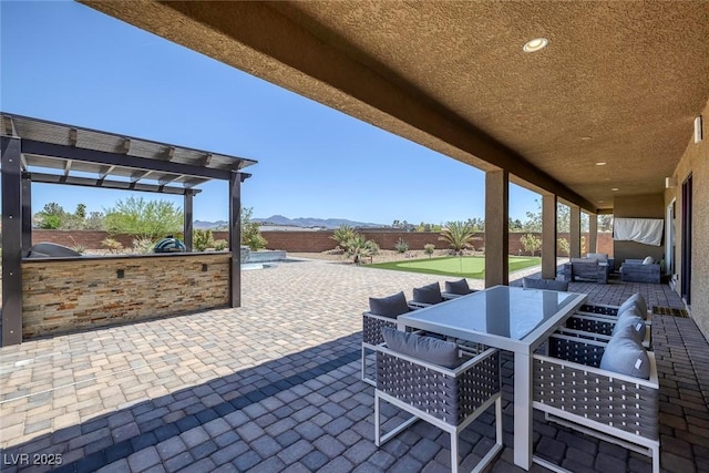 11088 Westcroft Way, Las Vegas, NV 89183 - fenced backyard with outdoor lounge area, an outdoor kitchen, a patio area, outdoor dining space, and a mountain view