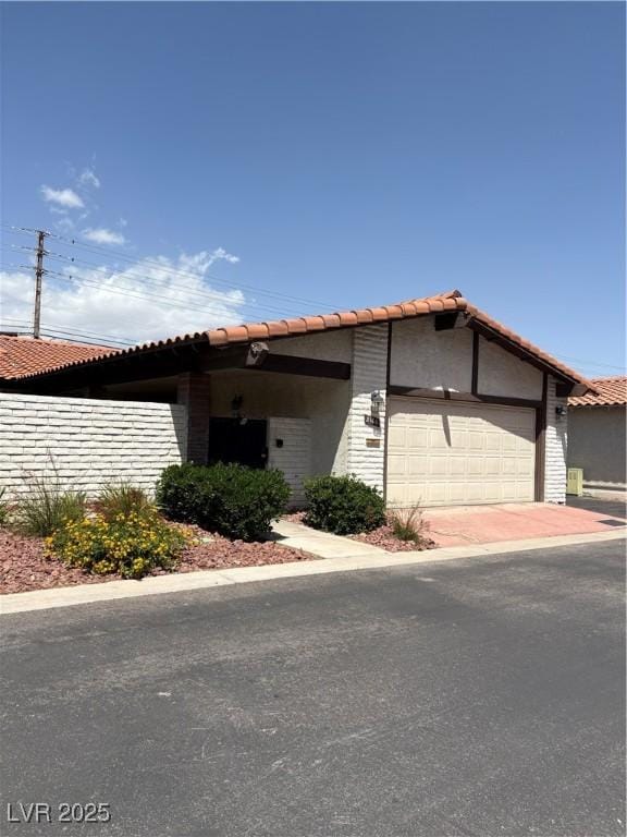 2100 Plaza Del Padre, Las Vegas, NV 89102 - view of front of house with stucco siding, an attached garage, and a tiled roof