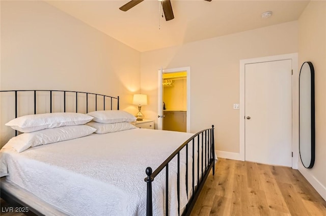 251 S Green Valley Pkwy Unit 1311, Henderson, NV 89012 - bedroom with light wood-type flooring, a spacious closet, baseboards, a ceiling fan, and a closet