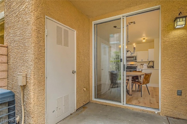 251 S Green Valley Pkwy Unit 1311, Henderson, NV 89012 - property entrance featuring a sink, stucco siding, and cooling unit