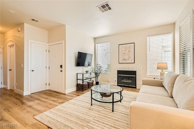 251 S Green Valley Pkwy Unit 1311, Henderson, NV 89012 - living room with light wood finished floors, baseboards, a fireplace, and healthy amount of natural light