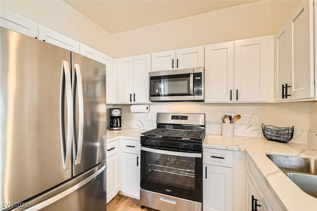 251 S Green Valley Pkwy Unit 1311, Henderson, NV 89012 - kitchen featuring stainless steel appliances, white cabinetry, and light stone counters