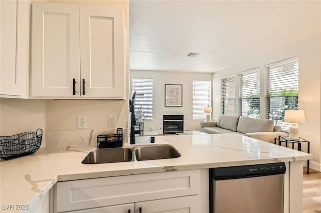 251 S Green Valley Pkwy Unit 1311, Henderson, NV 89012 - kitchen with dishwasher, a sink, white cabinets, open floor plan, and a peninsula