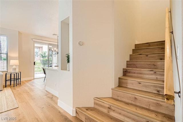 251 S Green Valley Pkwy Unit 1311, Henderson, NV 89012 - staircase featuring wood finished floors, baseboards, and a chandelier