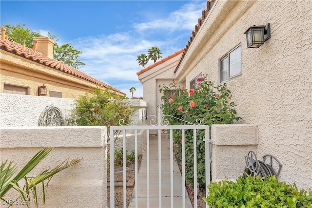 7929 Ben Hogan Dr, Las Vegas, NV 89149 - view of property exterior with a gate, a tile roof, stucco siding, and fence