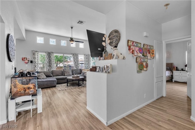 7929 Ben Hogan Dr, Las Vegas, NV 89149 - hallway featuring light wood-style floors, a towering ceiling, and baseboards
