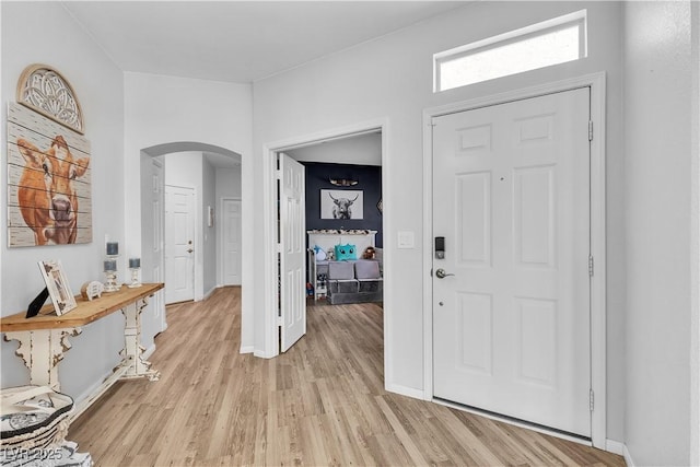 7929 Ben Hogan Dr, Las Vegas, NV 89149 - foyer entrance with arched walkways, light wood-style floors, and baseboards