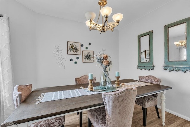 7929 Ben Hogan Dr, Las Vegas, NV 89149 - dining space featuring a chandelier, baseboards, and wood finished floors