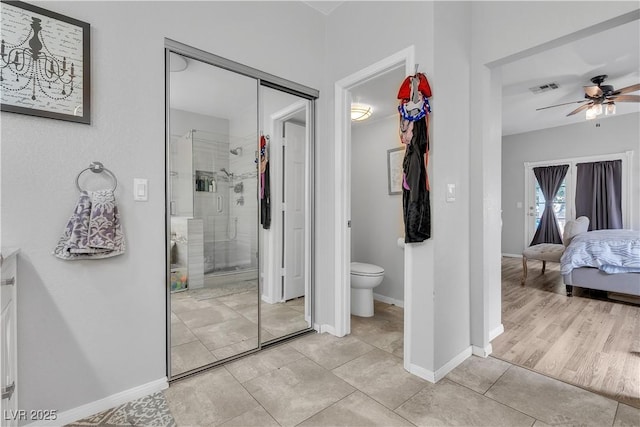 7929 Ben Hogan Dr, Las Vegas, NV 89149 - full bathroom with a ceiling fan, a stall shower, tile patterned floors, connected bathroom, and toilet