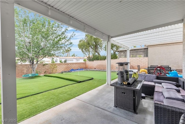 7929 Ben Hogan Dr, Las Vegas, NV 89149 - view of patio featuring an outdoor hangout area, an area to practice putting, and a fenced backyard