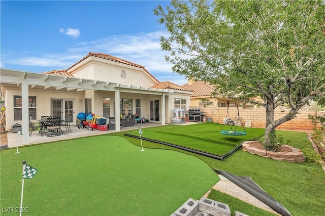 7929 Ben Hogan Dr, Las Vegas, NV 89149 - rear view of property featuring a putting area, a patio, fence, and stucco siding