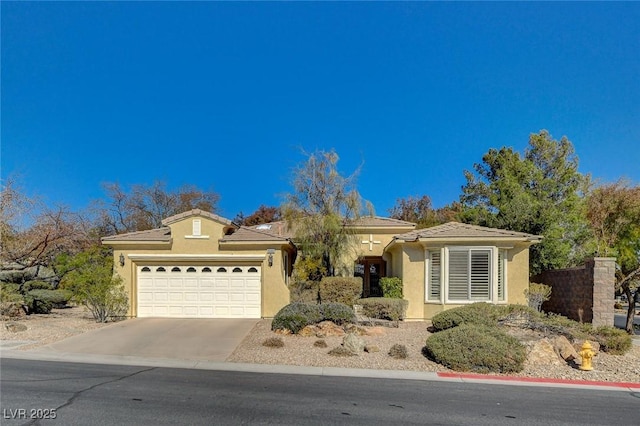10302 Cara Mia Ct, Las Vegas, NV 89135 - view of front of house with stucco siding, an attached garage, and concrete driveway