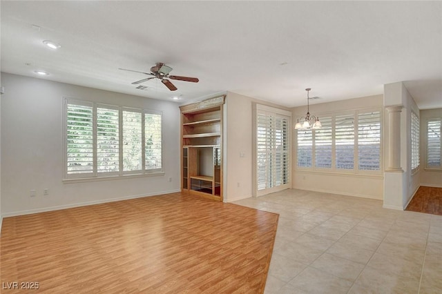 10302 Cara Mia Ct, Las Vegas, NV 89135 - unfurnished living room with a ceiling fan, a chandelier, baseboards, recessed lighting, and light tile patterned flooring