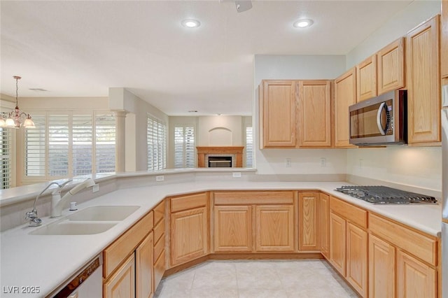10302 Cara Mia Ct, Las Vegas, NV 89135 - kitchen featuring a sink, stainless steel appliances, light brown cabinets, light countertops, and recessed lighting