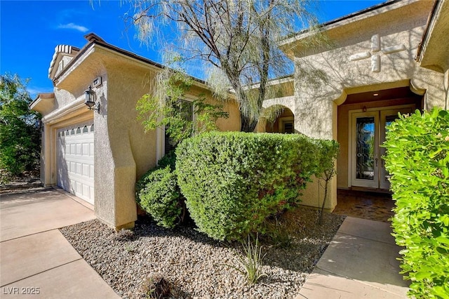 10302 Cara Mia Ct, Las Vegas, NV 89135 - view of side of property featuring stucco siding, driveway, and a garage