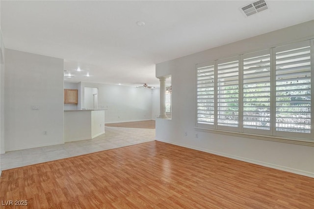 10302 Cara Mia Ct, Las Vegas, NV 89135 - unfurnished living room featuring light wood-style flooring, decorative columns, baseboards, and ceiling fan