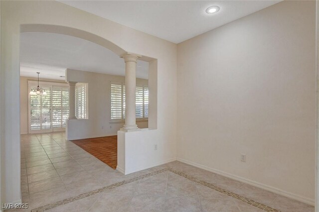 10302 Cara Mia Ct, Las Vegas, NV 89135 - empty room with decorative columns, healthy amount of natural light, baseboards, arched walkways, and recessed lighting