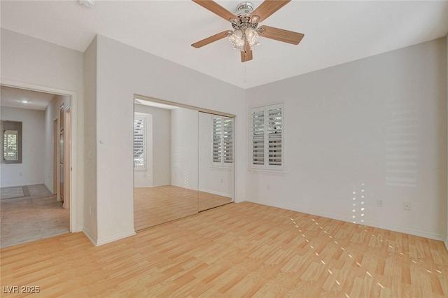 10302 Cara Mia Ct, Las Vegas, NV 89135 - unfurnished bedroom featuring wood finished floors, a closet, baseboards, and ceiling fan