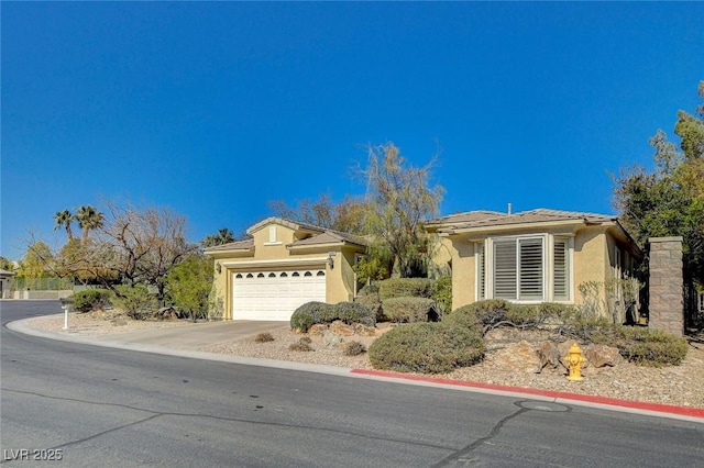 10302 Cara Mia Ct, Las Vegas, NV 89135 - view of front of house with stucco siding, a garage, and driveway