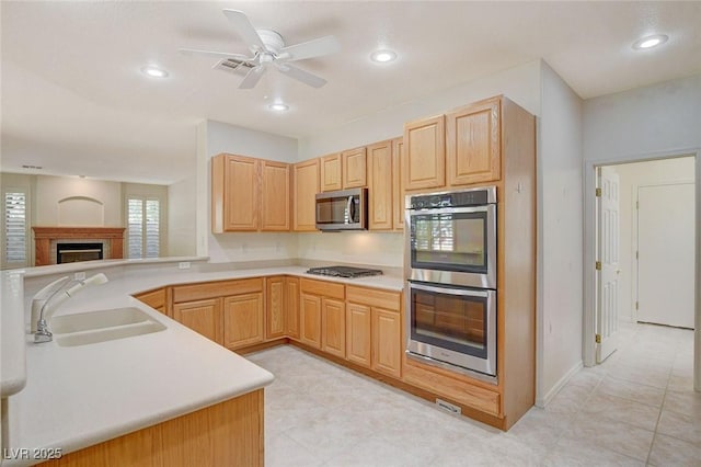 10302 Cara Mia Ct, Las Vegas, NV 89135 - kitchen with a sink, appliances with stainless steel finishes, light brown cabinets, light countertops, and recessed lighting