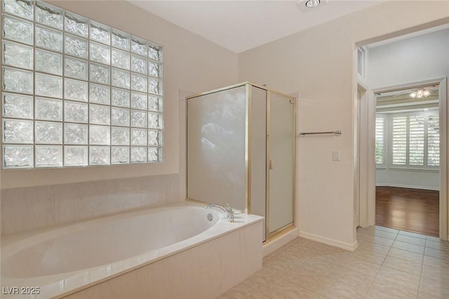 10302 Cara Mia Ct, Las Vegas, NV 89135 - bathroom with a garden tub, a stall shower, tile patterned flooring, and baseboards