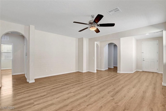248 Windmill Croft Dr, Las Vegas, NV 89148 - unfurnished room with arched walkways, a ceiling fan, light wood-style floors, and baseboards