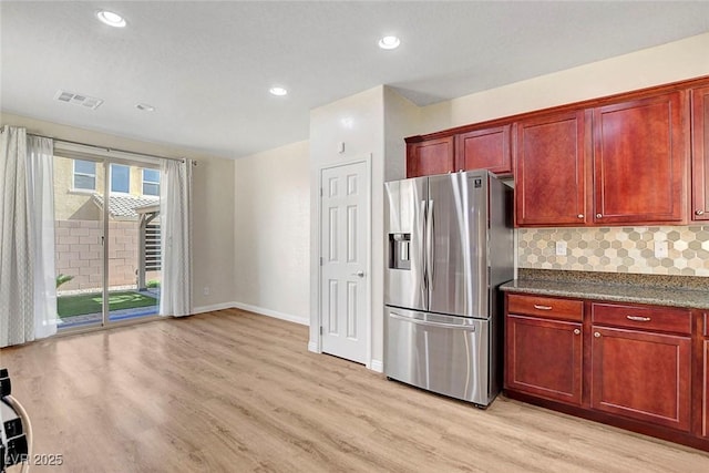 248 Windmill Croft Dr, Las Vegas, NV 89148 - kitchen with stainless steel fridge, reddish brown cabinets, light wood-style flooring, backsplash, and recessed lighting