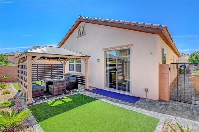 248 Windmill Croft Dr, Las Vegas, NV 89148 - rear view of house featuring an outdoor hangout area, a gazebo, stucco siding, a patio area, and a gate
