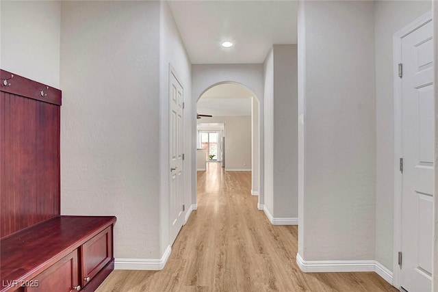 248 Windmill Croft Dr, Las Vegas, NV 89148 - corridor with light wood-type flooring, arched walkways, and baseboards