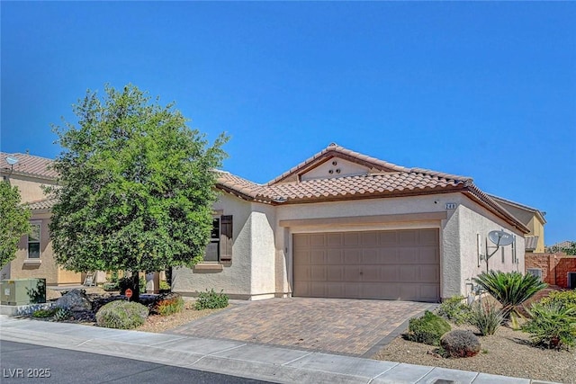 248 Windmill Croft Dr, Las Vegas, NV 89148 - mediterranean / spanish home featuring a tile roof, stucco siding, an attached garage, and decorative driveway