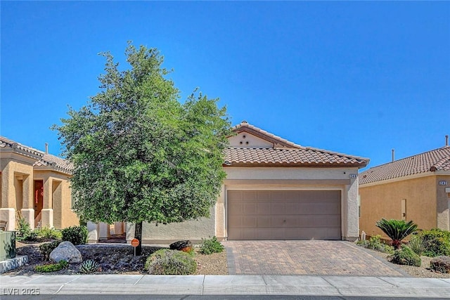 248 Windmill Croft Dr, Las Vegas, NV 89148 - mediterranean / spanish-style house featuring an attached garage, a tile roof, stucco siding, and driveway