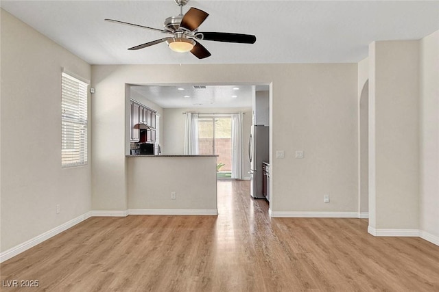 248 Windmill Croft Dr, Las Vegas, NV 89148 - unfurnished living room with light wood-type flooring, ceiling fan, and baseboards