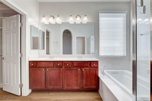 248 Windmill Croft Dr, Las Vegas, NV 89148 - bathroom featuring double vanity, a bath, and wood finished floors