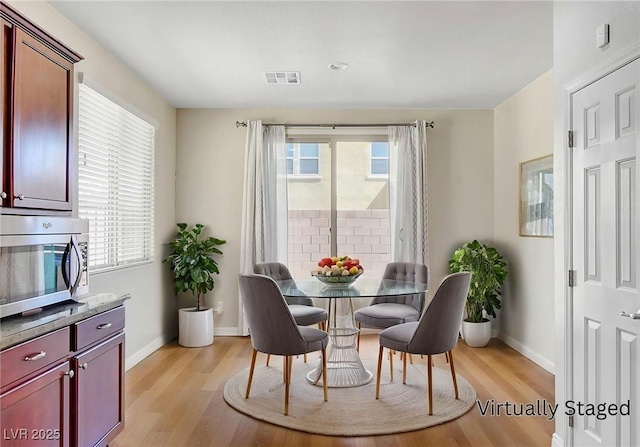248 Windmill Croft Dr, Las Vegas, NV 89148 - dining space with healthy amount of natural light, light wood-type flooring, and baseboards