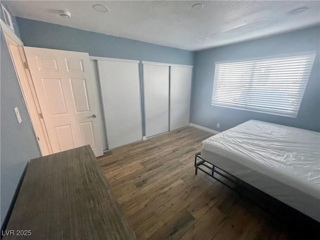 501 S Maryland Pkwy Unit C17, Las Vegas, NV 89101 - bedroom with hardwood / wood-style flooring, multiple closets, and baseboards