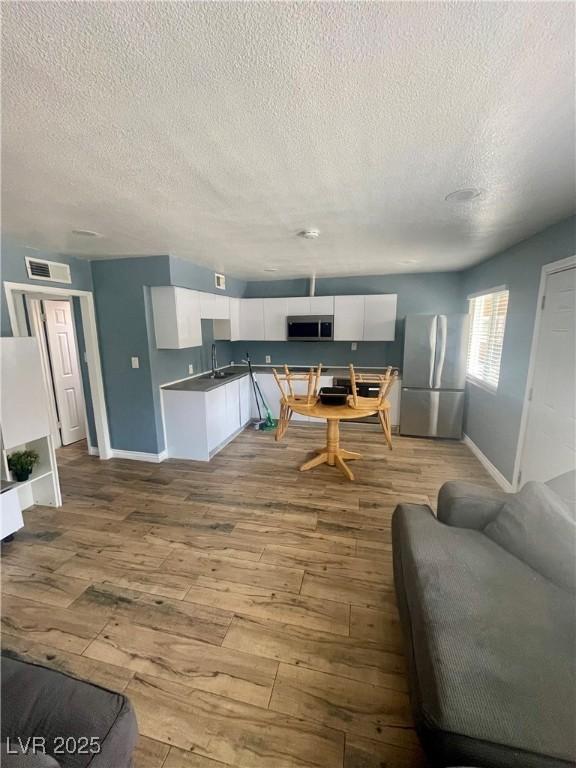 501 S Maryland Pkwy Unit C17, Las Vegas, NV 89101 - living area with hardwood / wood-style flooring, baseboards, and a textured ceiling