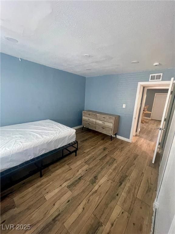 501 S Maryland Pkwy Unit C17, Las Vegas, NV 89101 - bedroom with wood finished floors, baseboards, and a textured ceiling