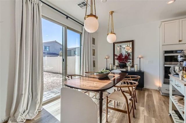 dining area featuring light wood-style floors
