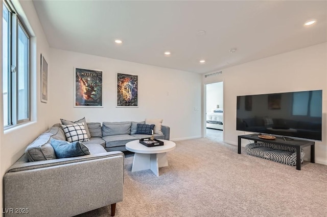 living room with carpet floors, recessed lighting, and baseboards