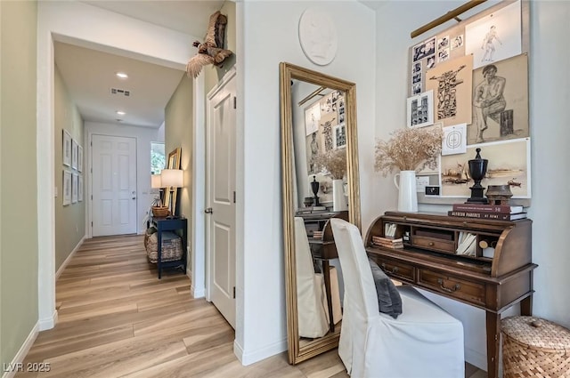 hall with light wood-type flooring, baseboards, and recessed lighting